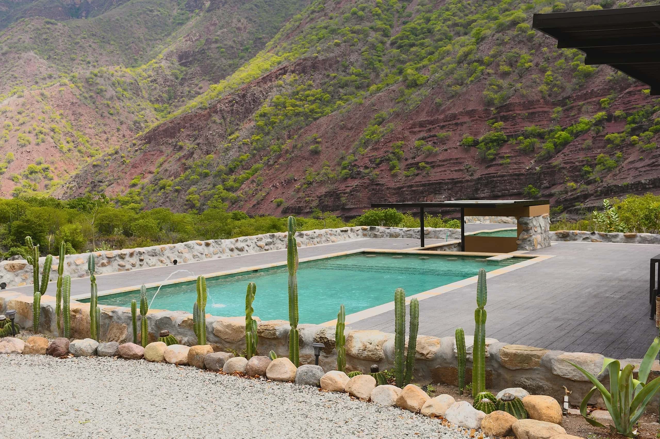 Pool lined with cacti at a country lodge at the foot of the Chicamocha Canyon walls