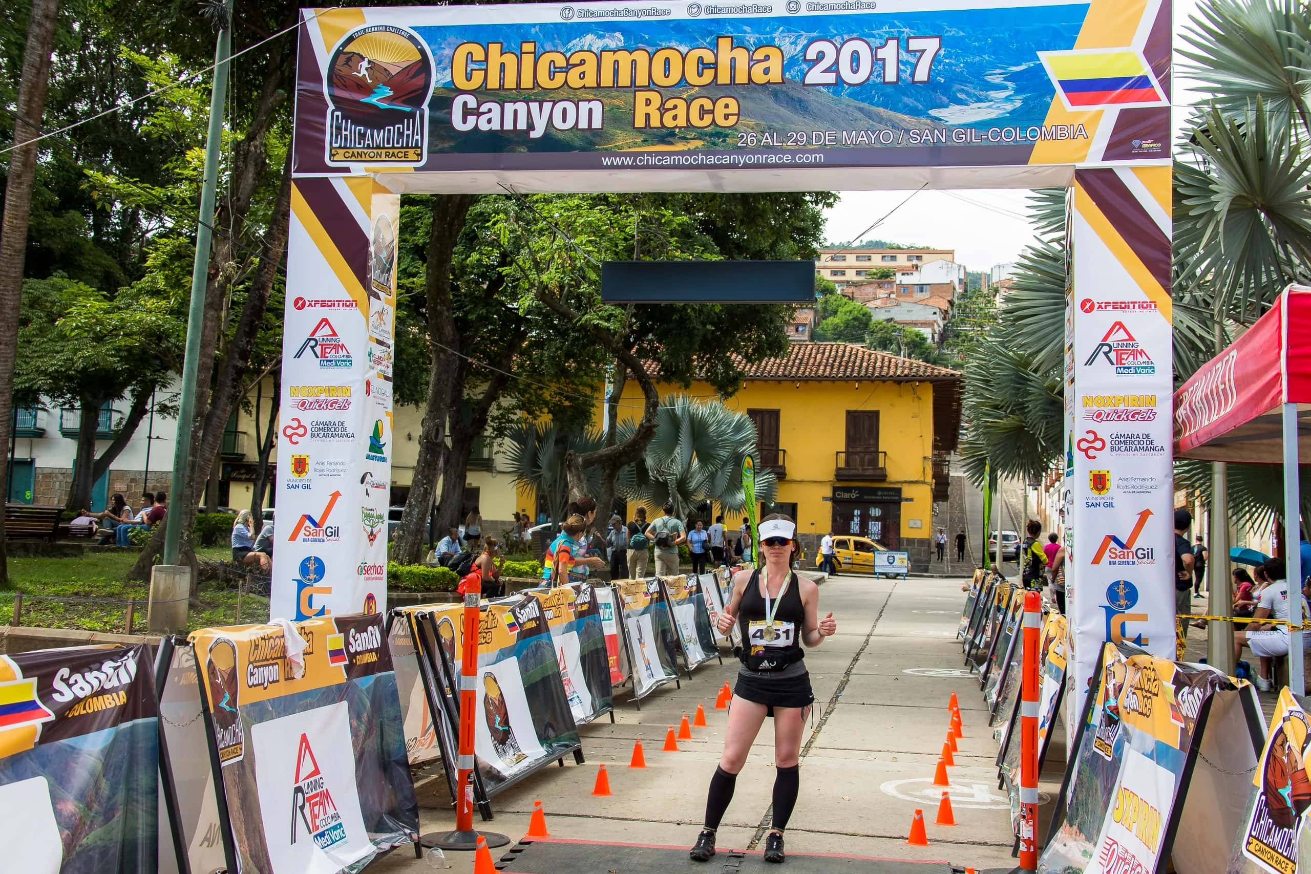 Runner arriving at the San Gil finish line between barriers and cones