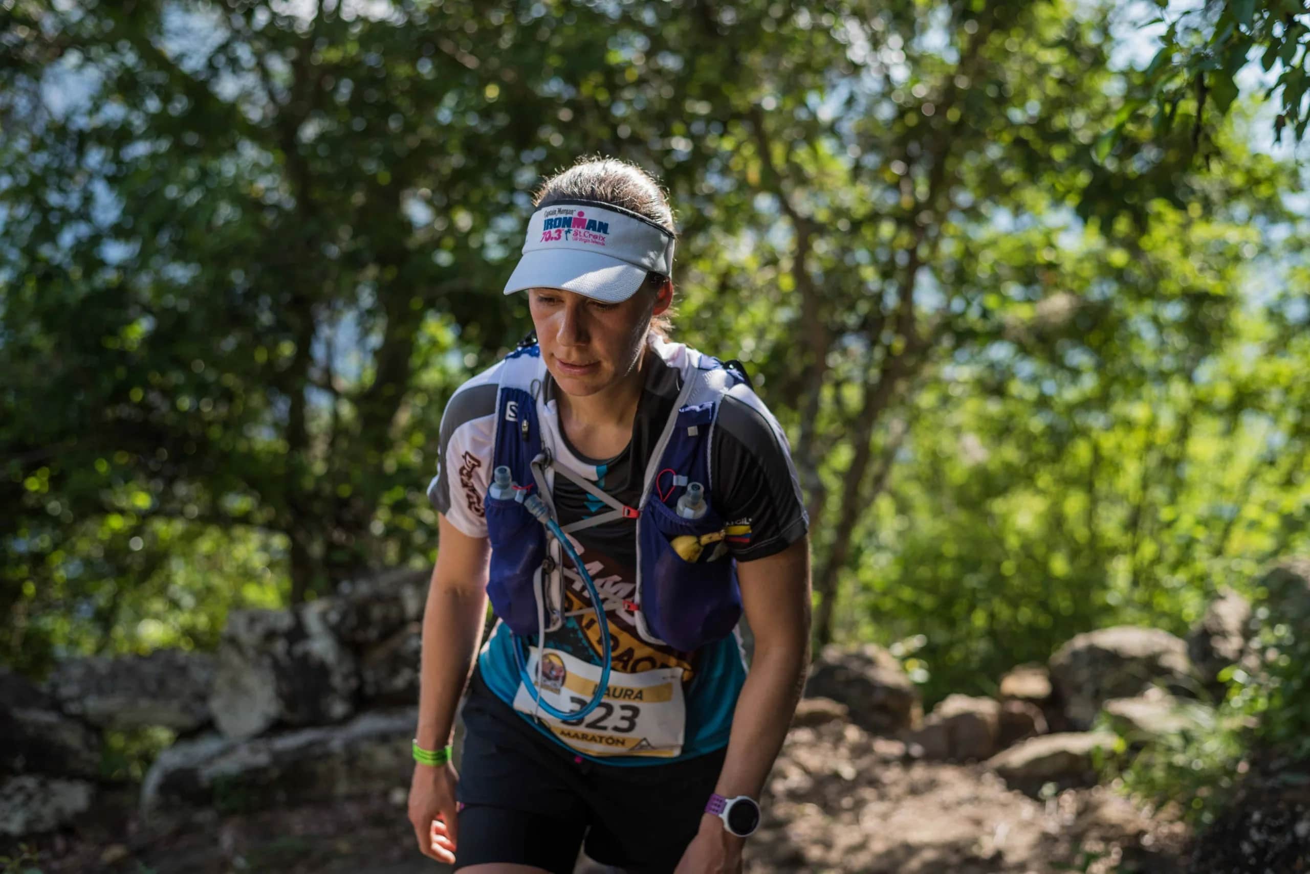 Marathon runner focused on a wooded section