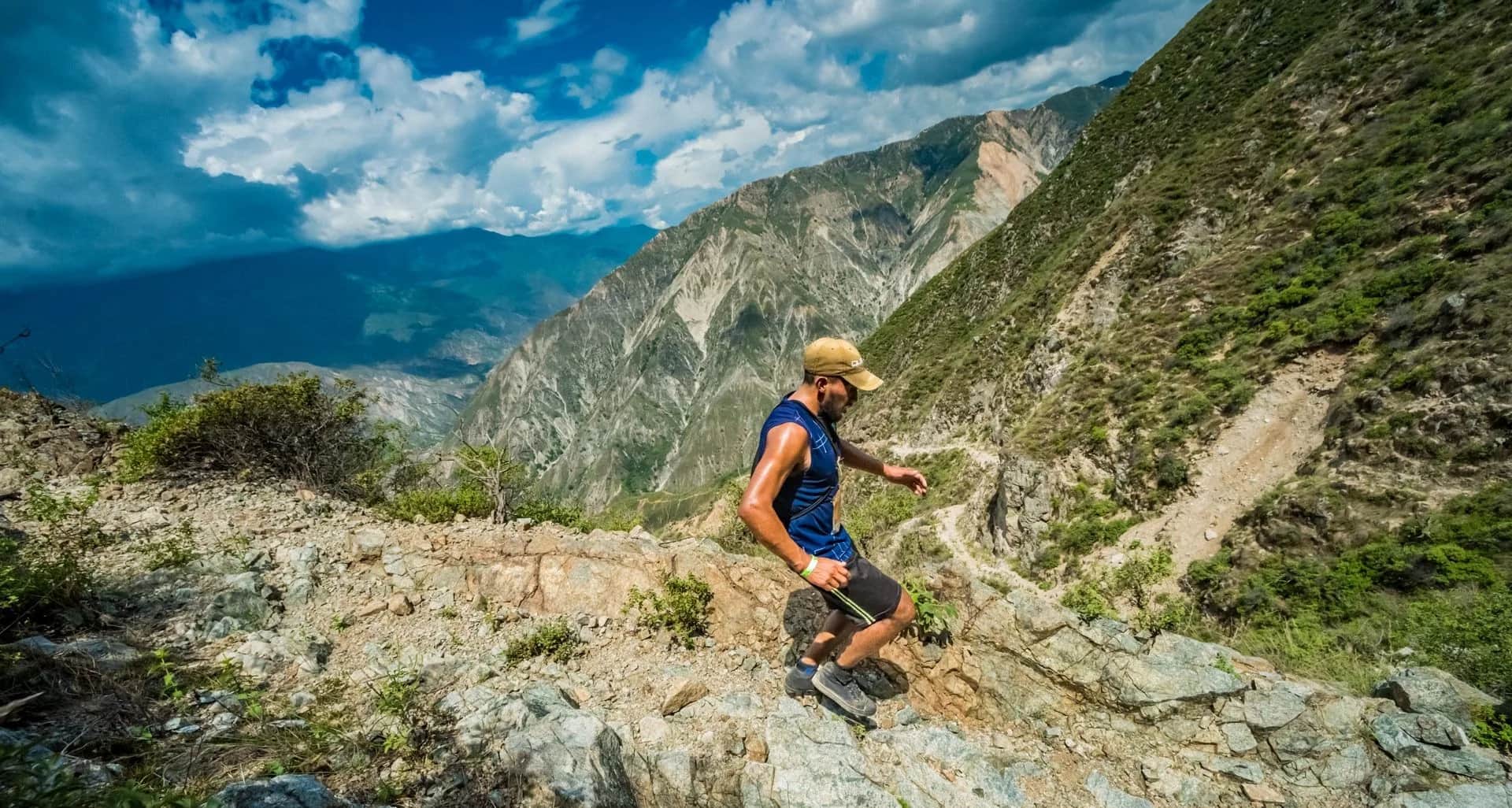 Runner crossing a rocky section on the canyon edge