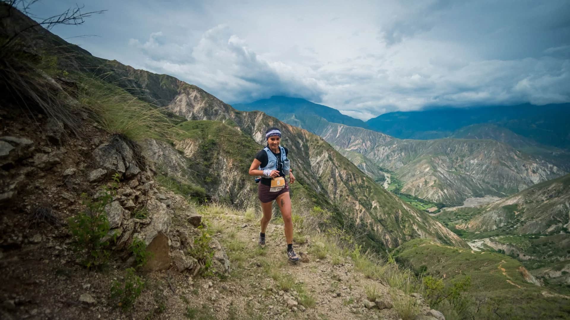 Runner on a narrow trail along a canyon slope