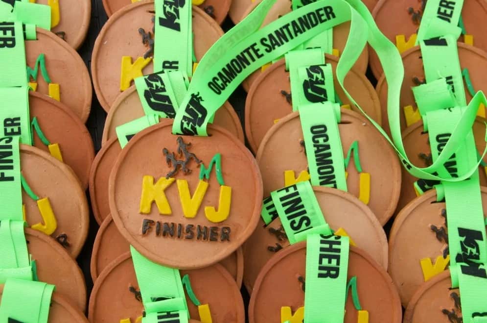 Clay KVJ finisher medals with green Ocamonte, Santander ribbons