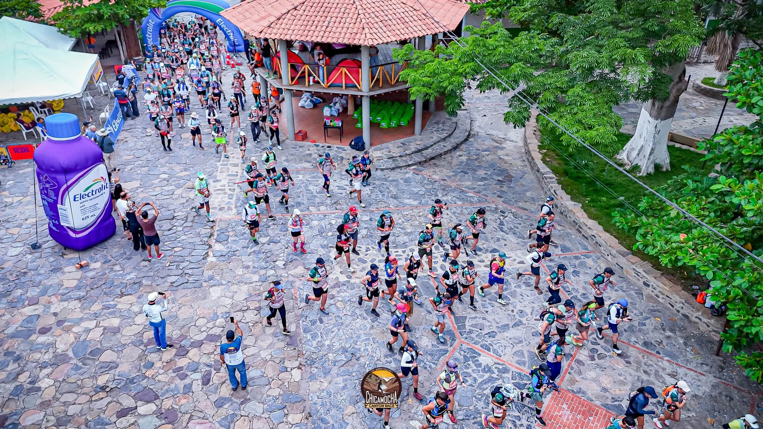 Aerial view of the start: hundreds of runners fill a cobbled square