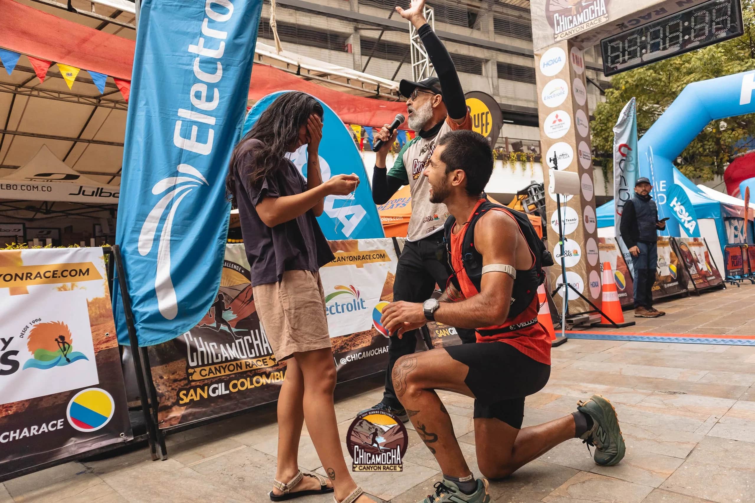 Runner kneels to propose to his partner in the finish area