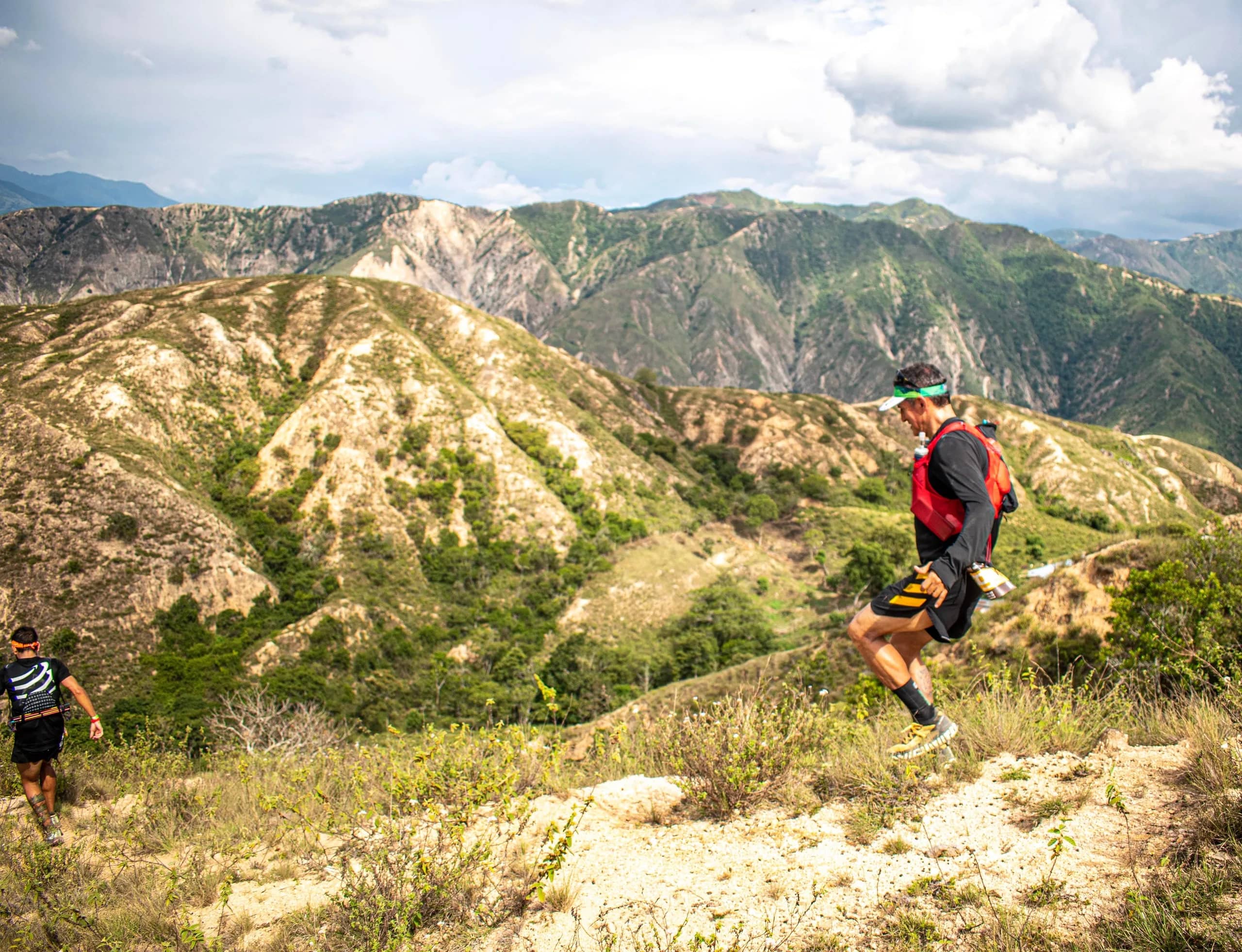 100-mile runners crossing eroded ochre slopes in the Chicamocha Canyon