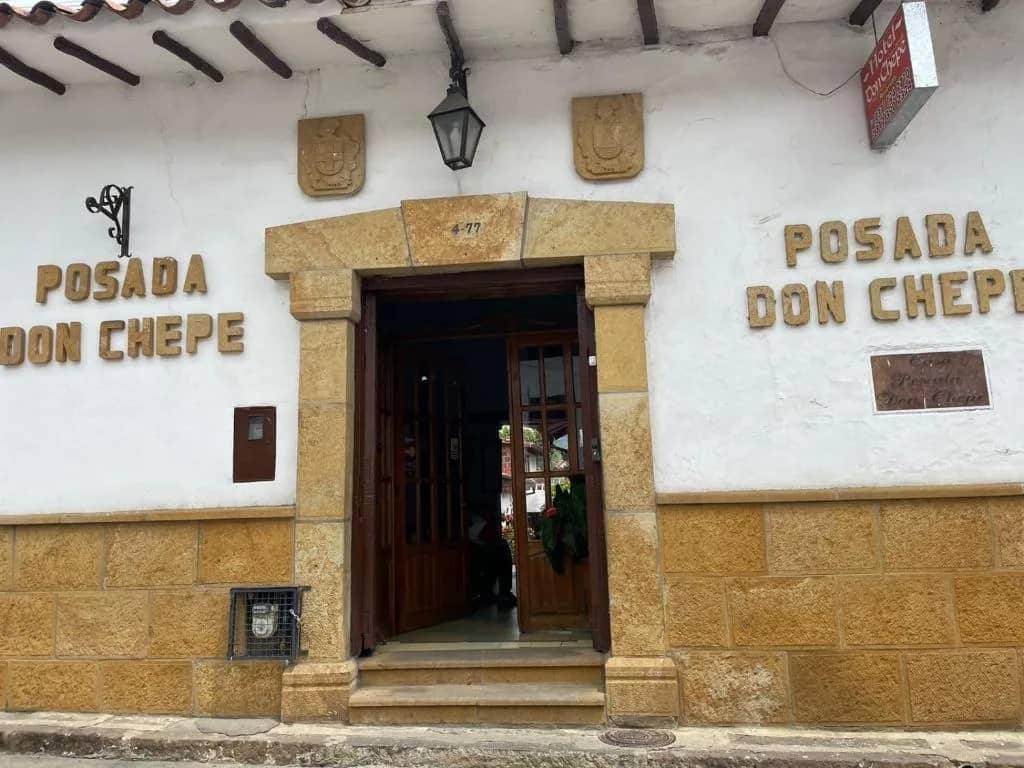 Stone-framed wooden doorway of Casa Posada Don Chepe