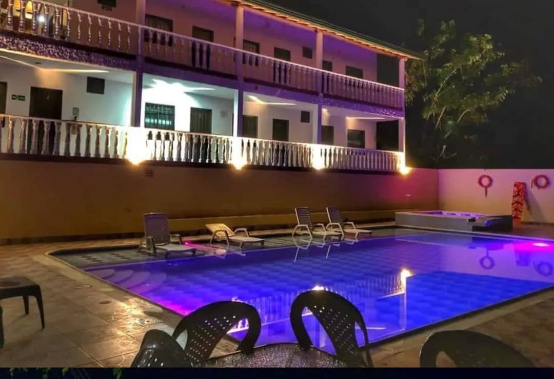 Pool lit up at night in front of the rooms at Hotel Natural Sea