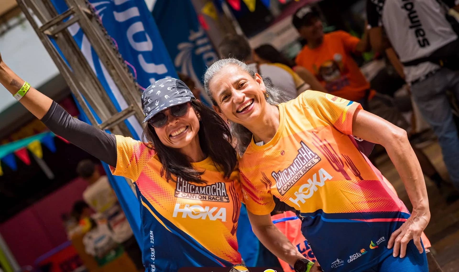 Two runners smiling in the official race shirt