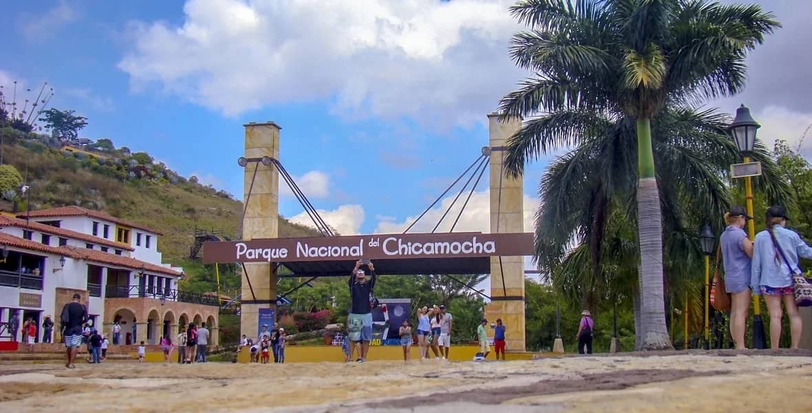 Entrance to Chicamocha National Park, with visitors and palm trees