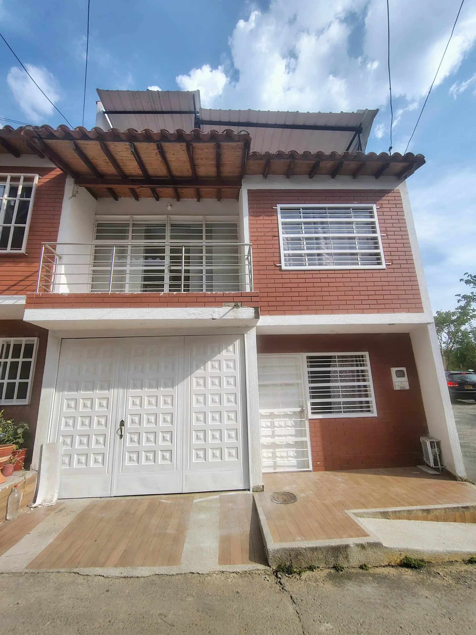 Brick facade of a three-story private house with a balcony