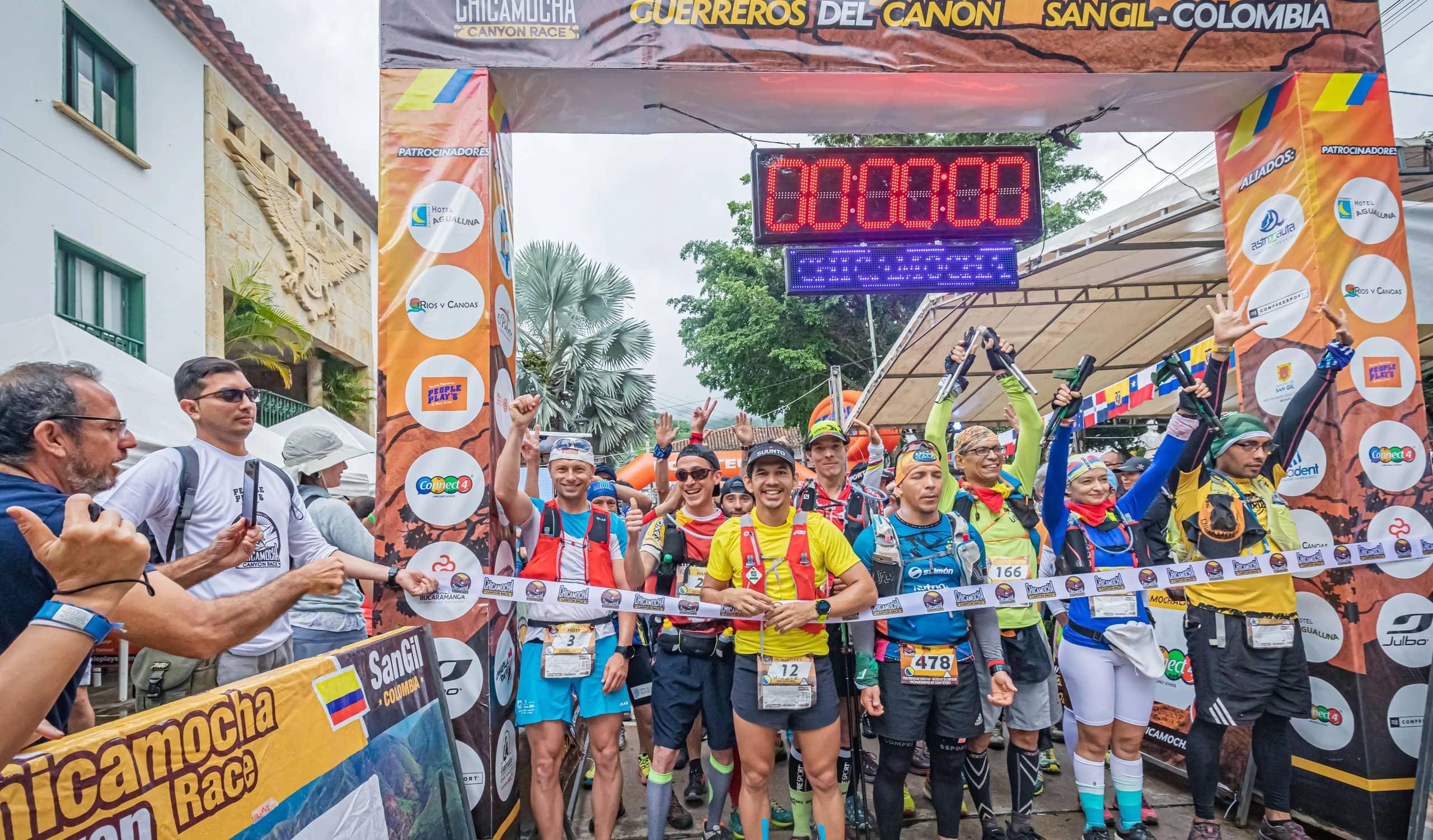 Runners on the 2019 start line, under the race arch and the official clock